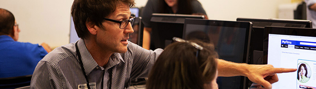 Student service center employee working with a student