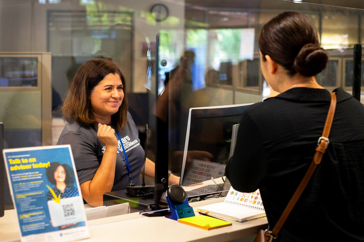 Student speaking with an advisor.