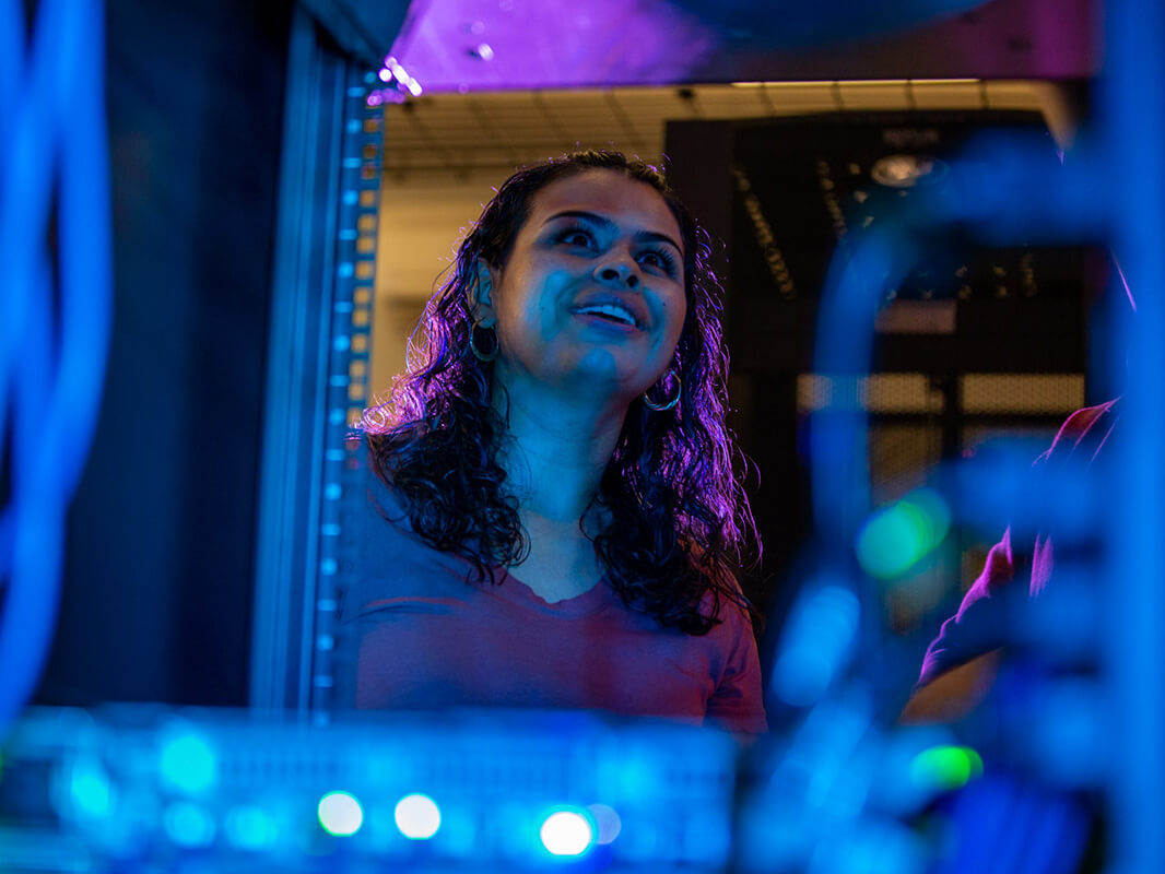 A student works on a server in the Student Data Center
