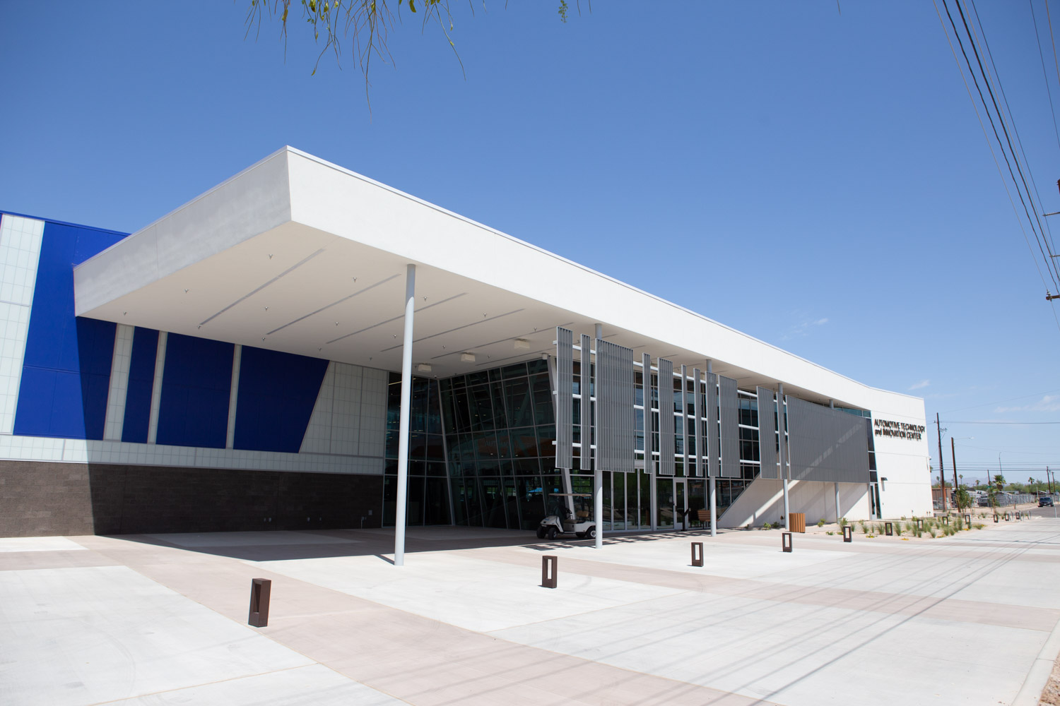 Automotive tech center, white building with desert landscaping.