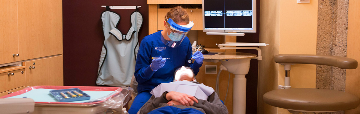 A dental hygiene student works on a volunteer