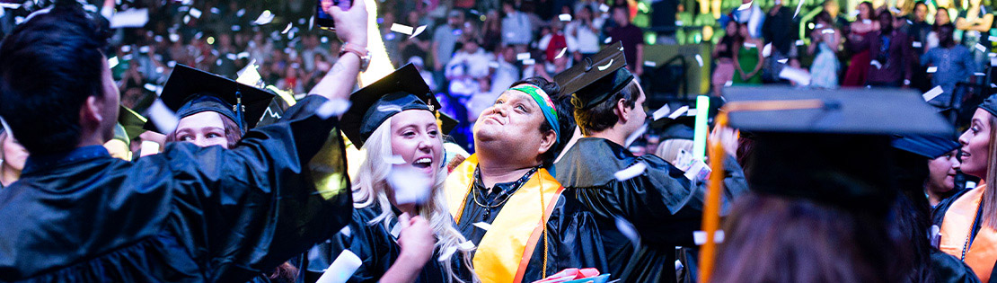 Two Graduates celebrate at a Pima Graduation