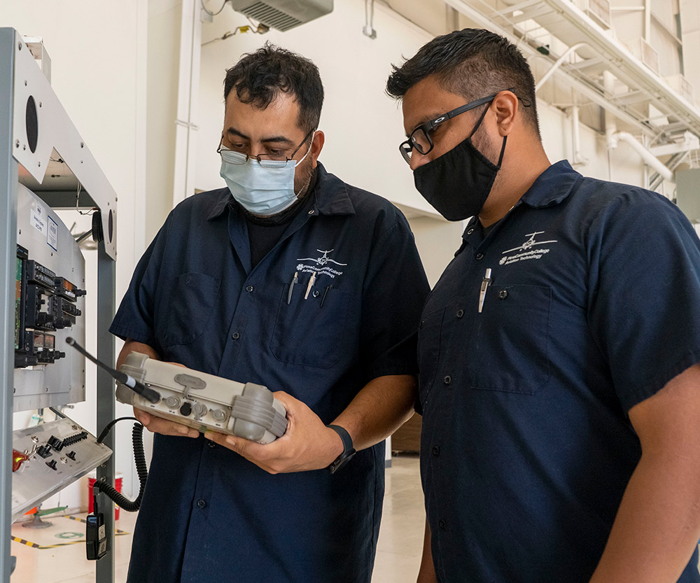 Two aviation students working in the Pima workshop