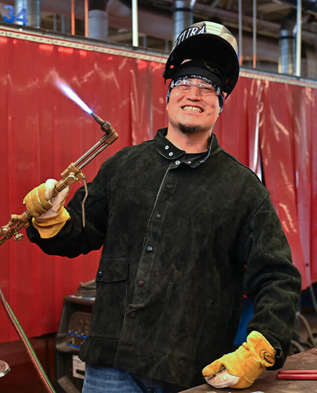 Will poses for the camera in the welding and fabrication lab.
