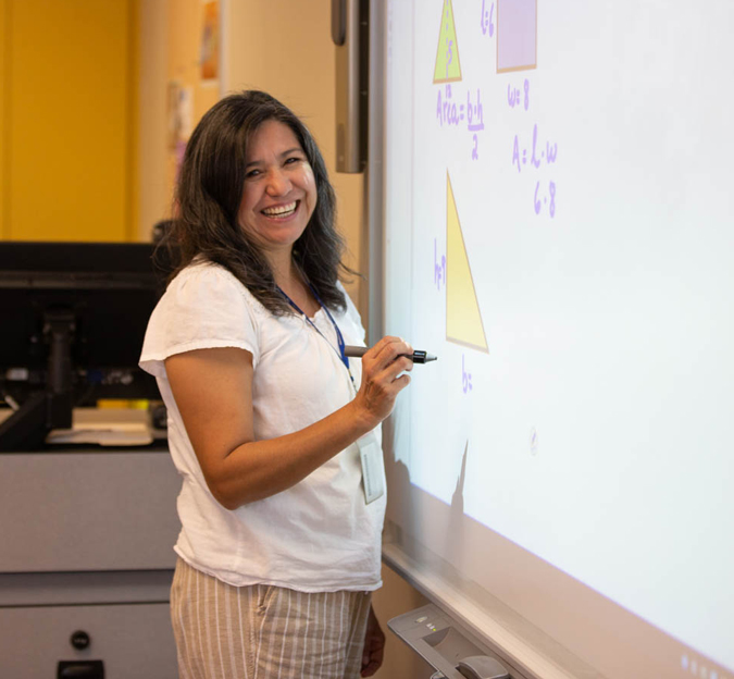 Consuelo Carrillo at a whiteboard in her classroom