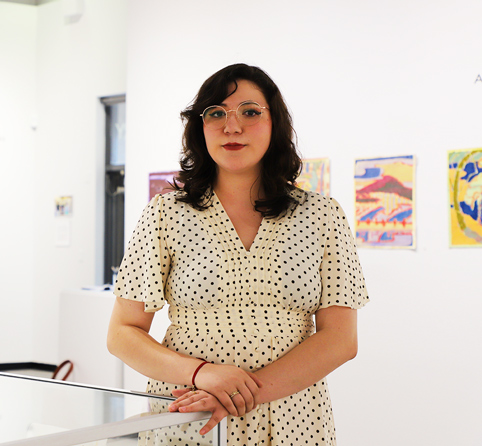 Vanessa Saavedra Stands inside Pima West Campus's Art Exhibit