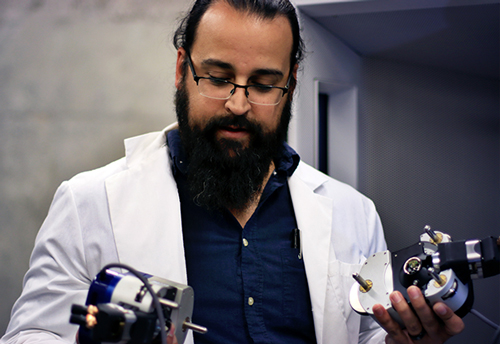 Jorge Munoz looks over lab items