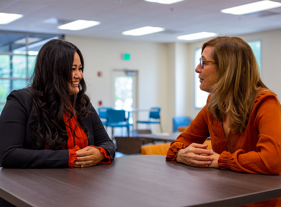 Elizabeth Soto sits chatting with her instructor,  Christine Wagner-Jonsson