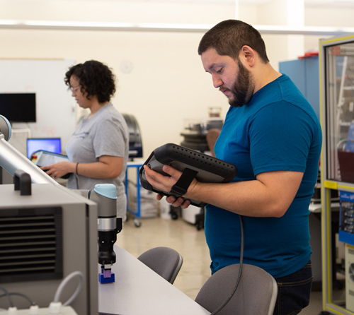 Two students work in the AIT Lab at Pima West Campus