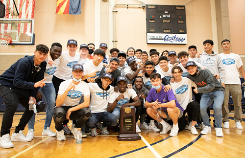 The Boys Soccer Team pose with their trophy