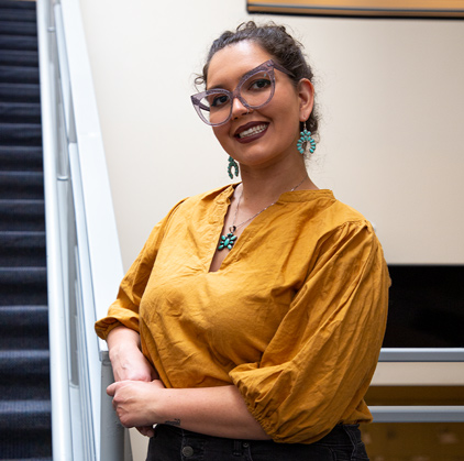 A picture of Izzy Madril on a staircase at Pima Downtown Campus