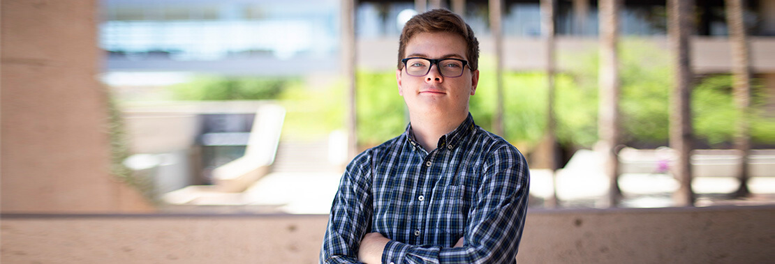 Samuel Phillips stands arms crossed outside of Pima's west campus