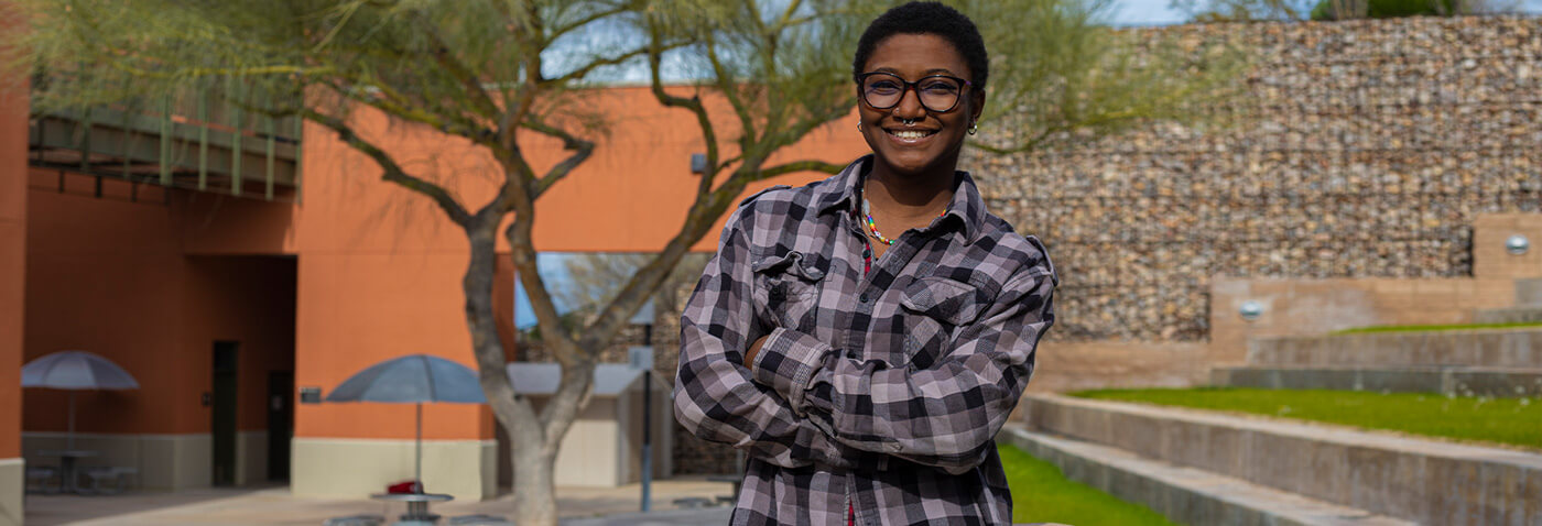 Fortune Dominic stands smiling at Pima west campus