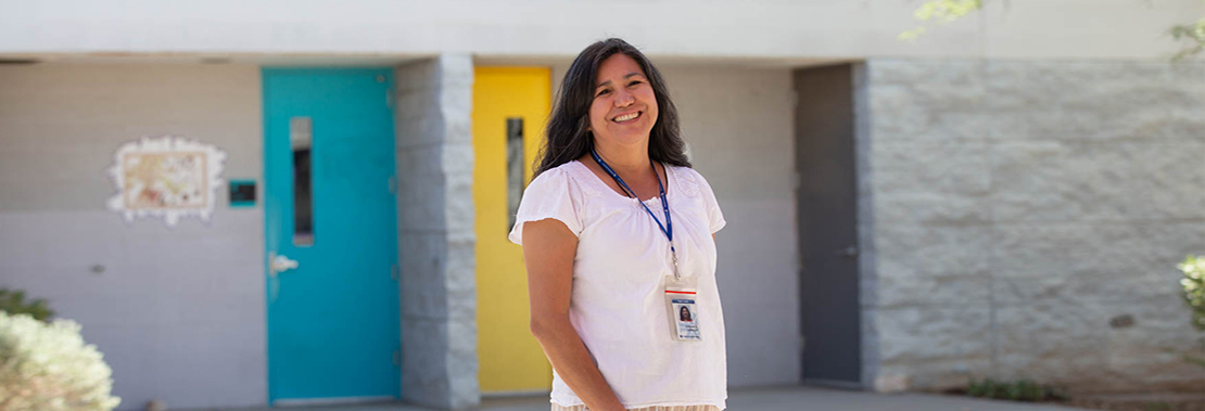 Image of Consuelo Carrillo Standing outside of her classrooms at El Pueblo Learning Center
