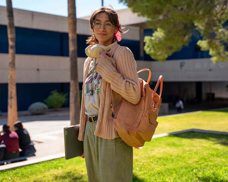 Student on the lawn at a pima campus.