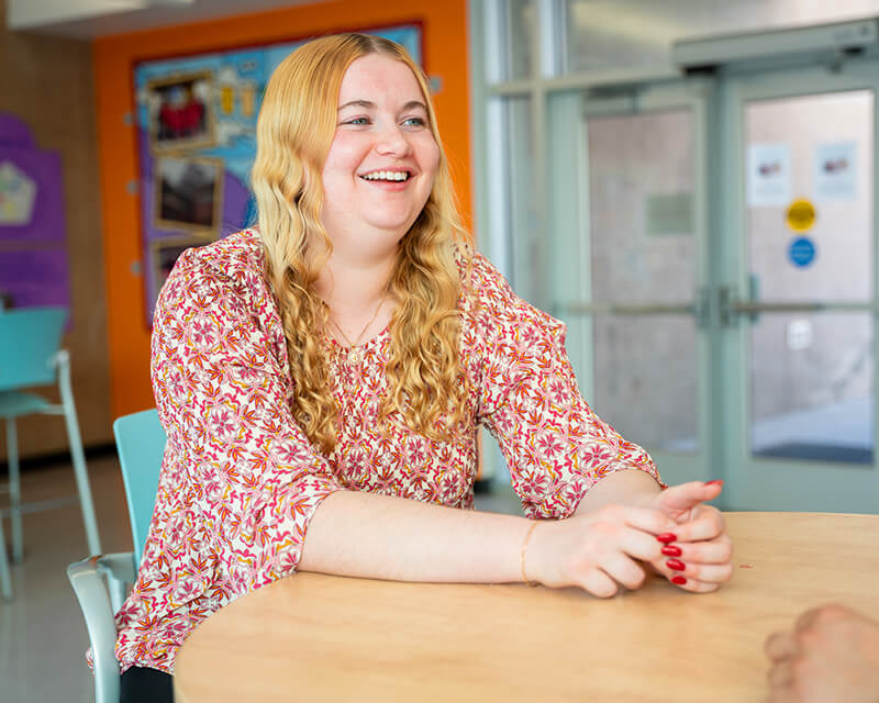 Student sitting at a table at Pima'e west campus.