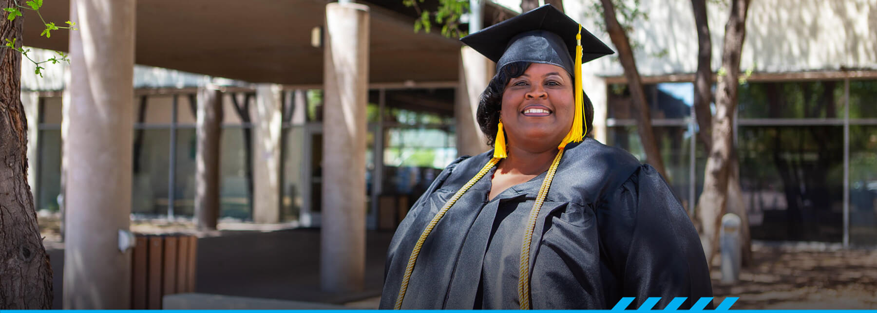 Stacie Williams poses for the camera in her graduation cap and gown.