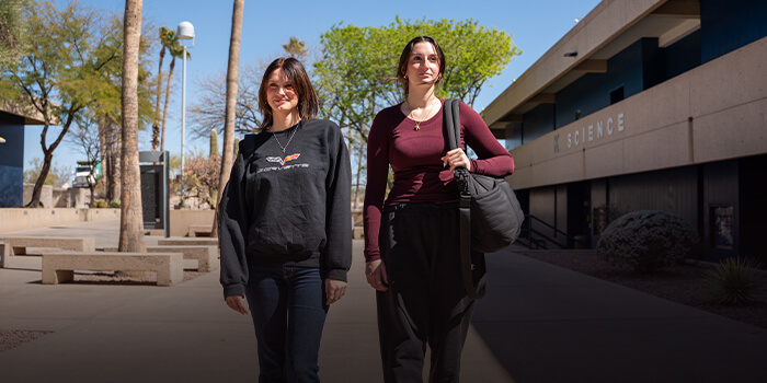 Two Students walk to class in a Pima breezeway