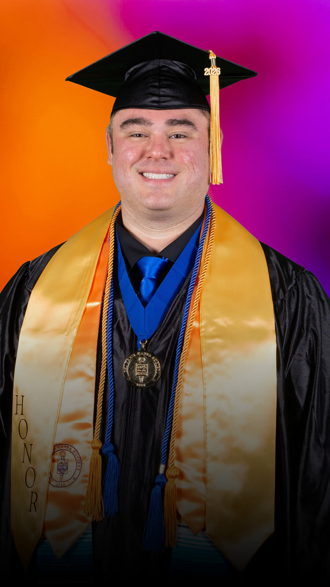 Alex poses for a graduation portrait.