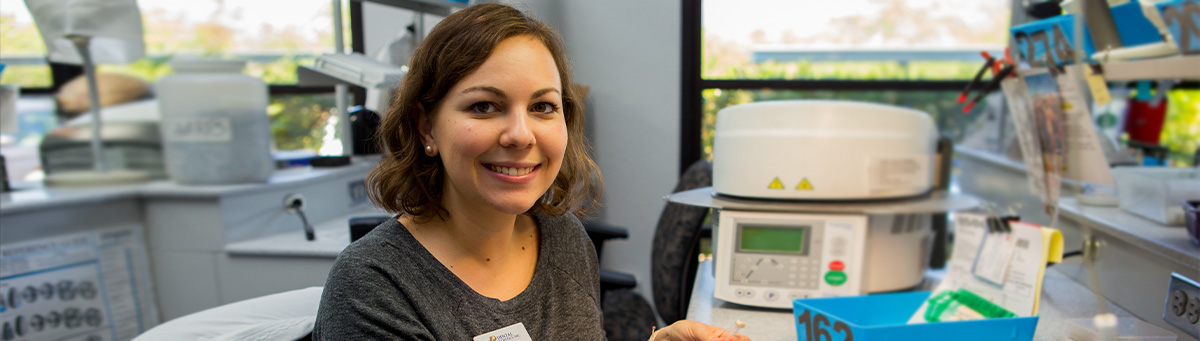 Two lab tech students work together on some data entry in a Pima lab