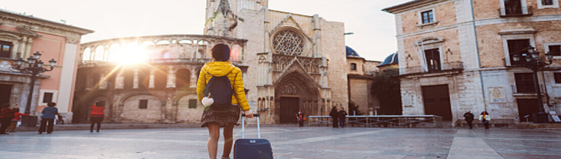 A student carrying luggage approaches a Europe City