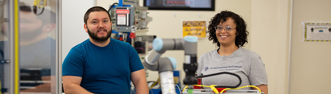 two students work on engineering equipment in a Pima Lab