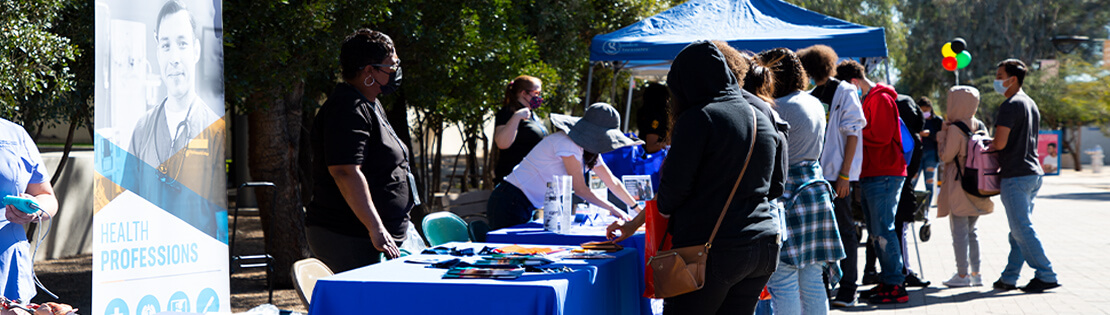 A group of Pima Tables at an event for the community at Pima's Downtown Campus