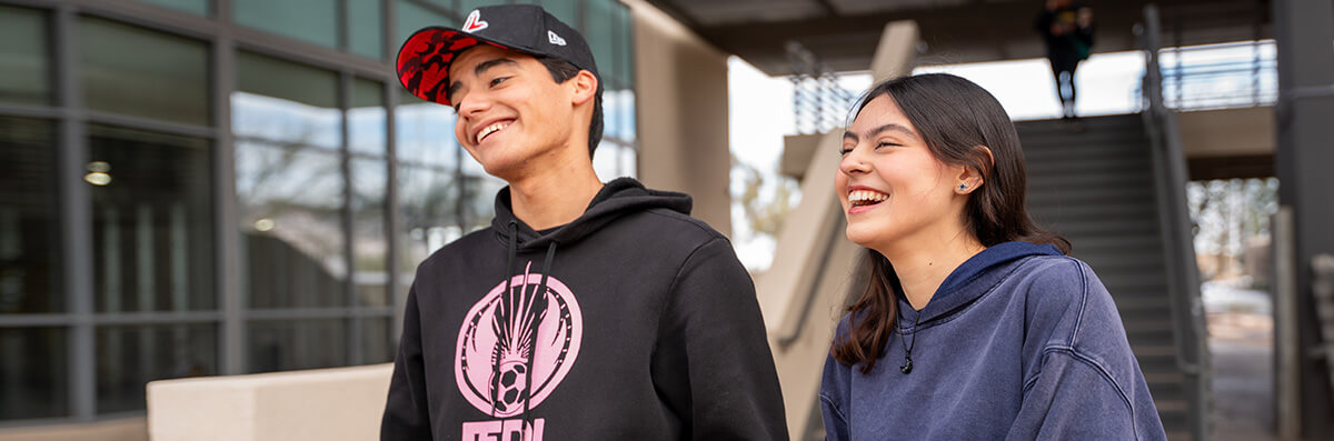 Two students walks smiling at DowntownCampus.
