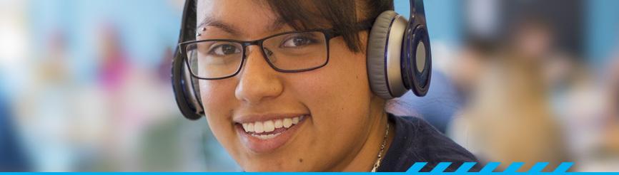 Pima Community College student wearing headphones and smiling
